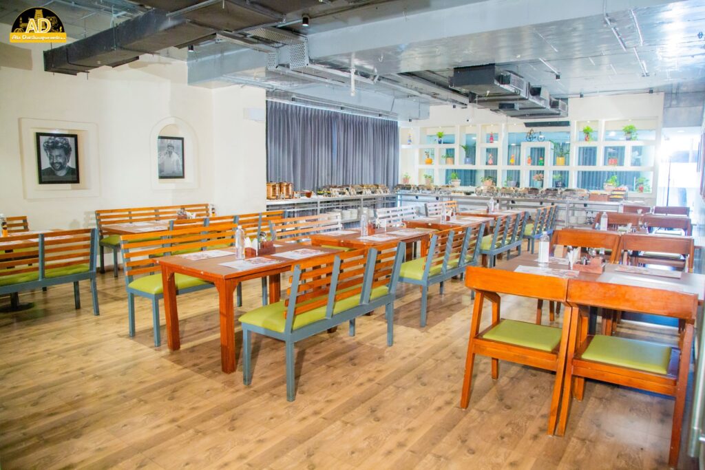 Ala Dakshinapuramlo - A beautiful ambience in the restaurant with chairs, tables, and photos hanging on the wall